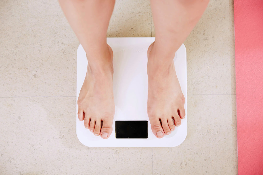 person stepping on a scale