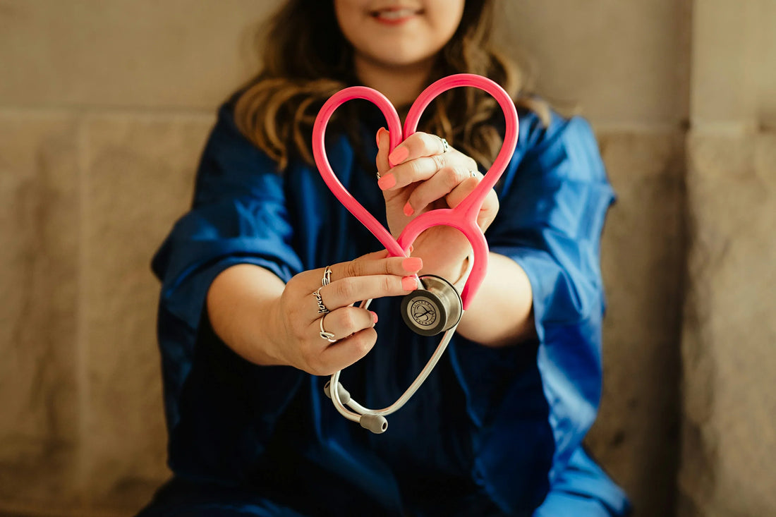 Girl bending a Stethoscope into the shape of a heart